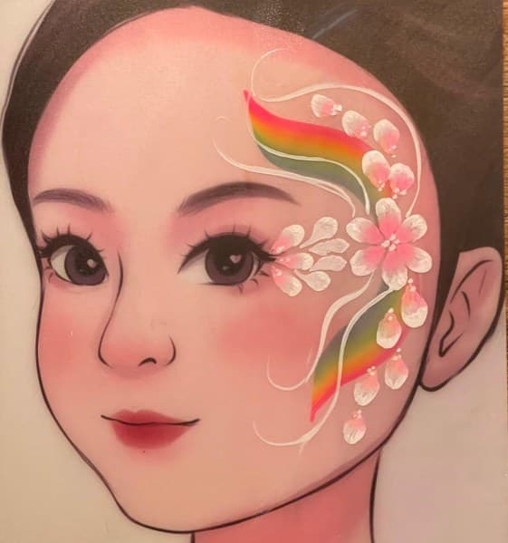 Regenboogbloem-schmink met roze bloem, witte swirls en kleurrijke bogen